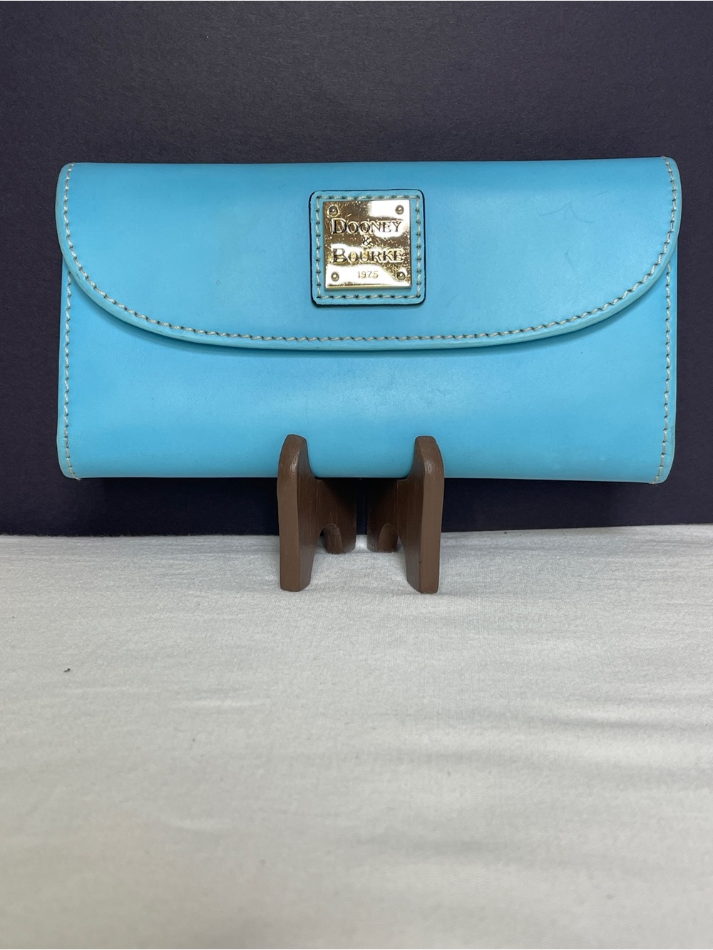 Dooney & Bourke Turquoise Leather Fold-Over Wallet with Gold Plaque